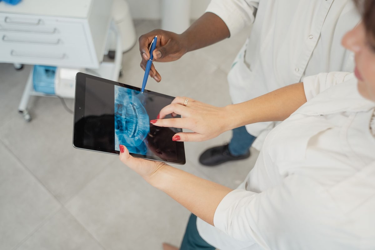 Dental office reception desk with a phone and scheduling paperwork