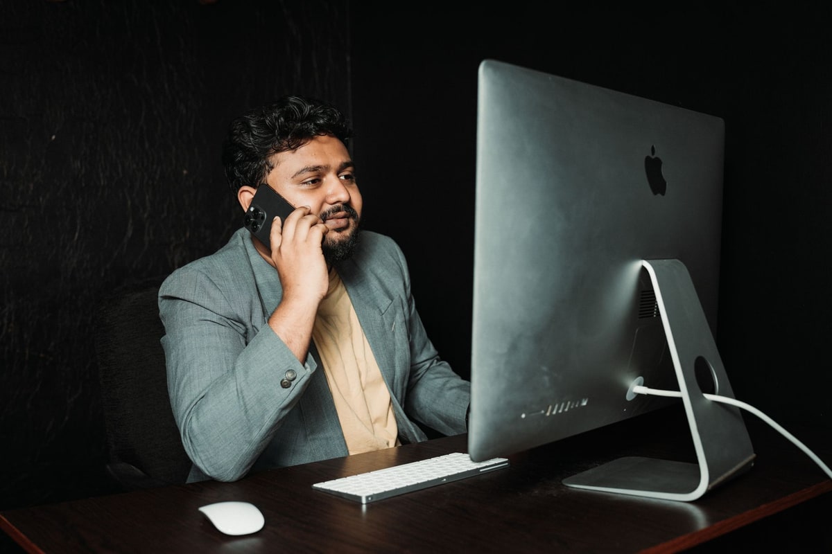 Front desk staff member answering a phone at a dental practice