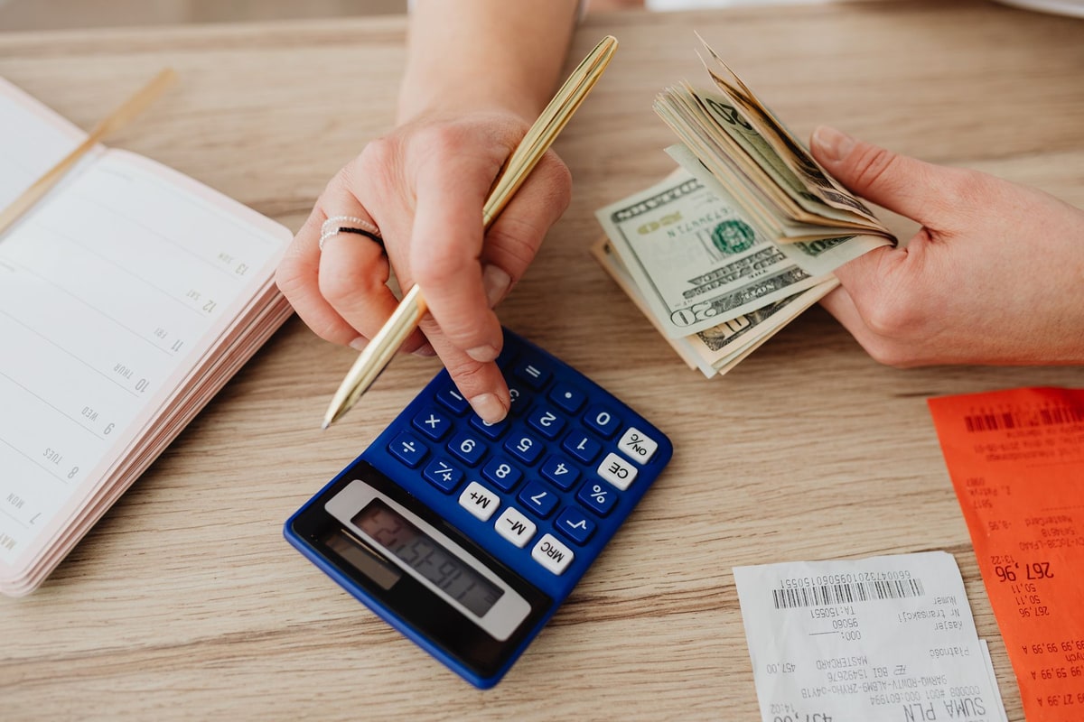 Small business owner reviewing admin cost paperwork at a desk