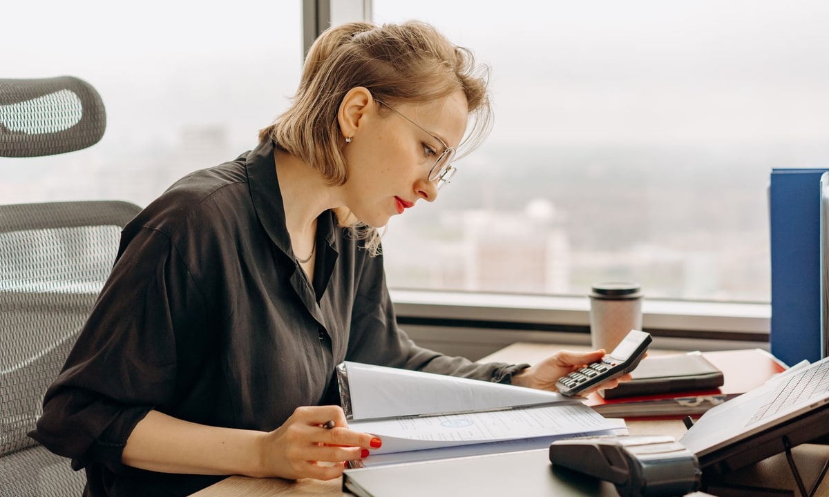 Small business owner deciding between hiring an admin assistant and automating