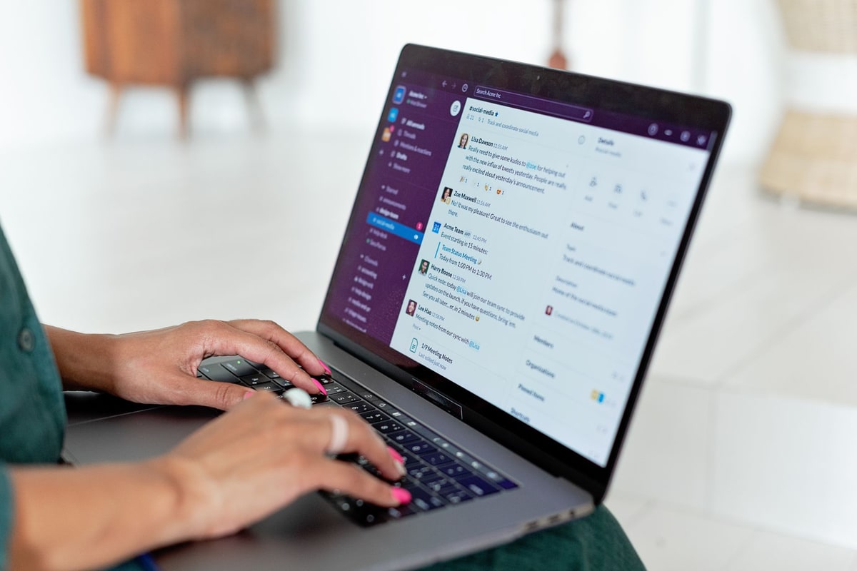 Person typing on a laptop during a customer chat conversation