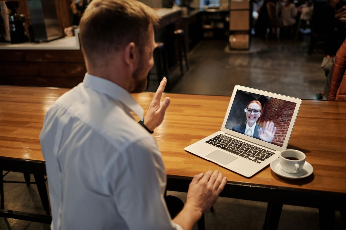Business owner reviewing a chat conversation dashboard on a laptop