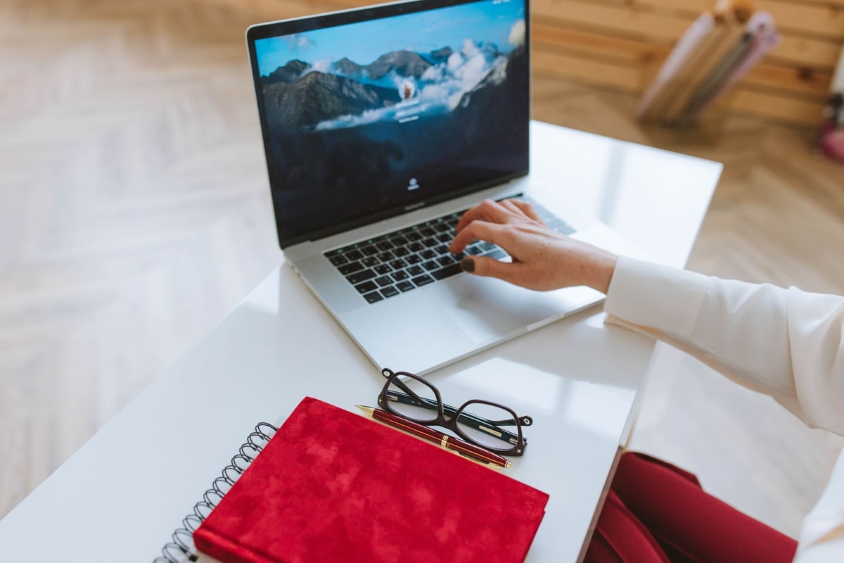 Writer typing a content draft on a laptop in an office