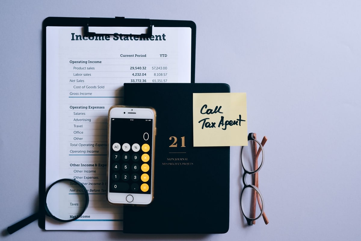 Calculator and call log open on a desk during planning