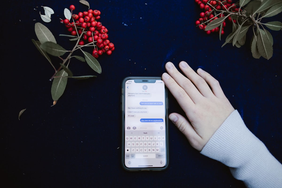 Business phone showing a customer message beside a scheduling screen