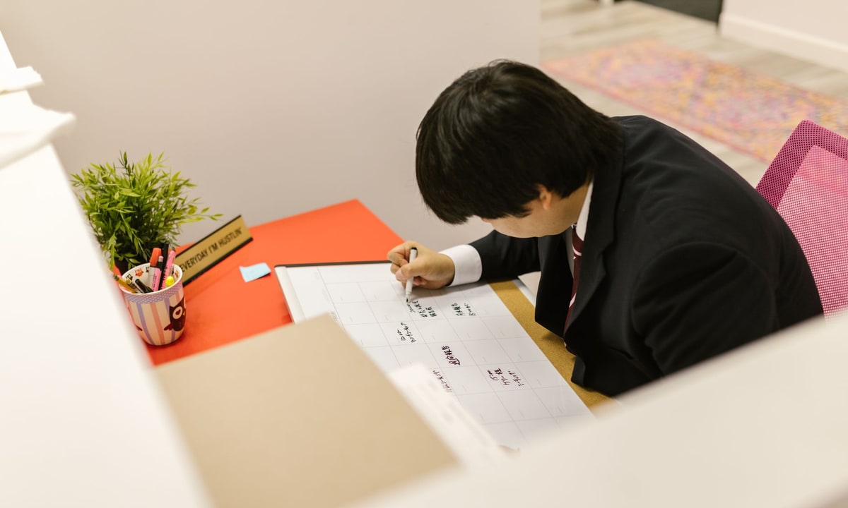 Service professional checking a booking calendar with confirmed appointments