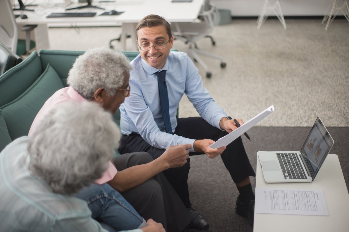 Financial advisor reviewing CRM records and onboarding tasks on a laptop