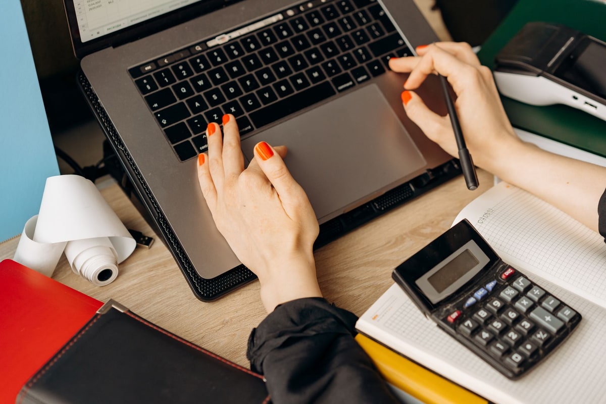 Bookkeeper reviewing invoices on a laptop