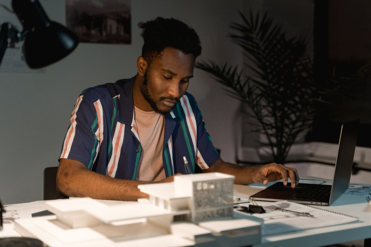 Small business owner working late on a laptop building automations at a desk