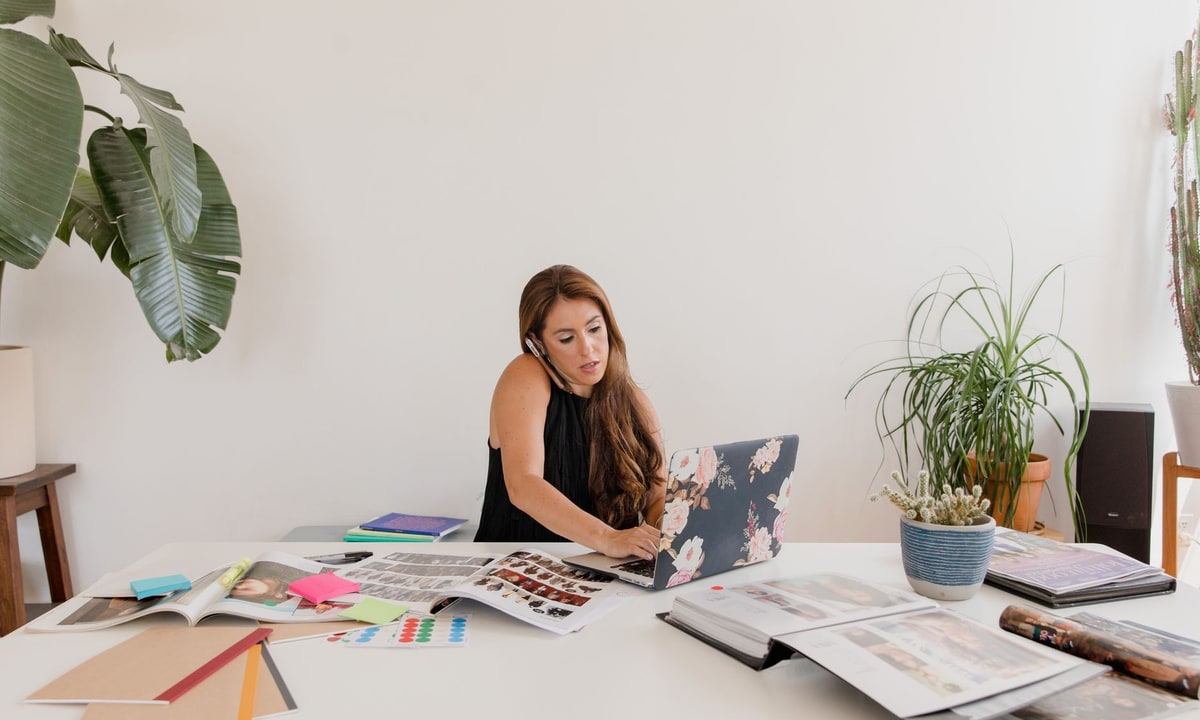 Small business owner comparing automation consultant proposal against DIY costs at a desk