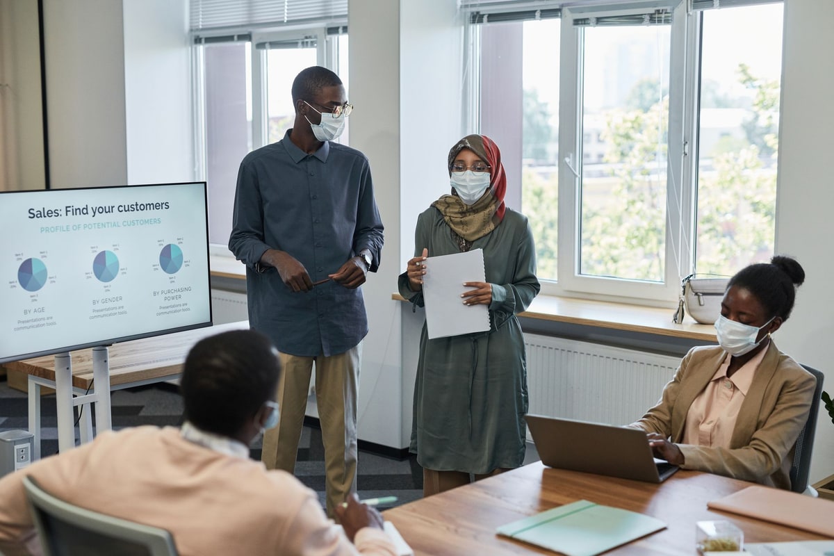 Sales team discussing qualified replies and handoffs in an office