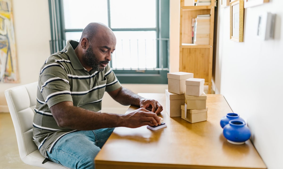 Small business owner checking lead follow-up messages on a smartphone in the office
