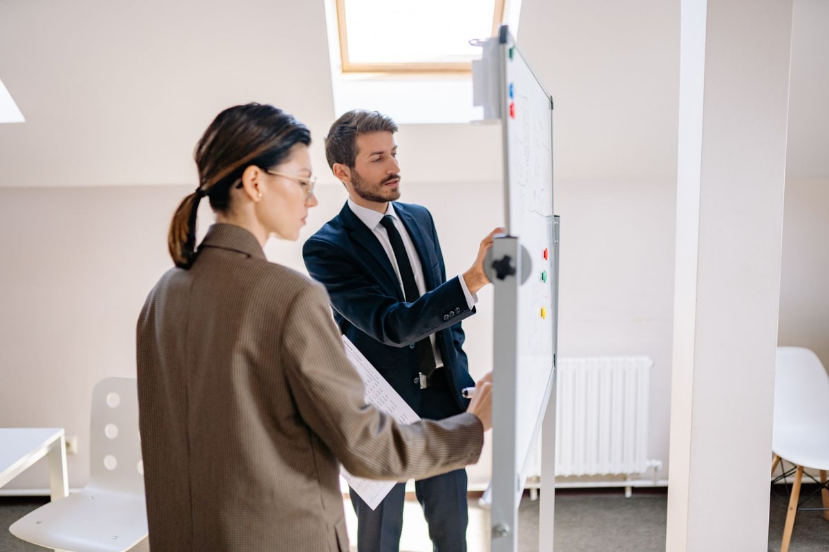 Small business team mapping CRM workflow requirements on a whiteboard