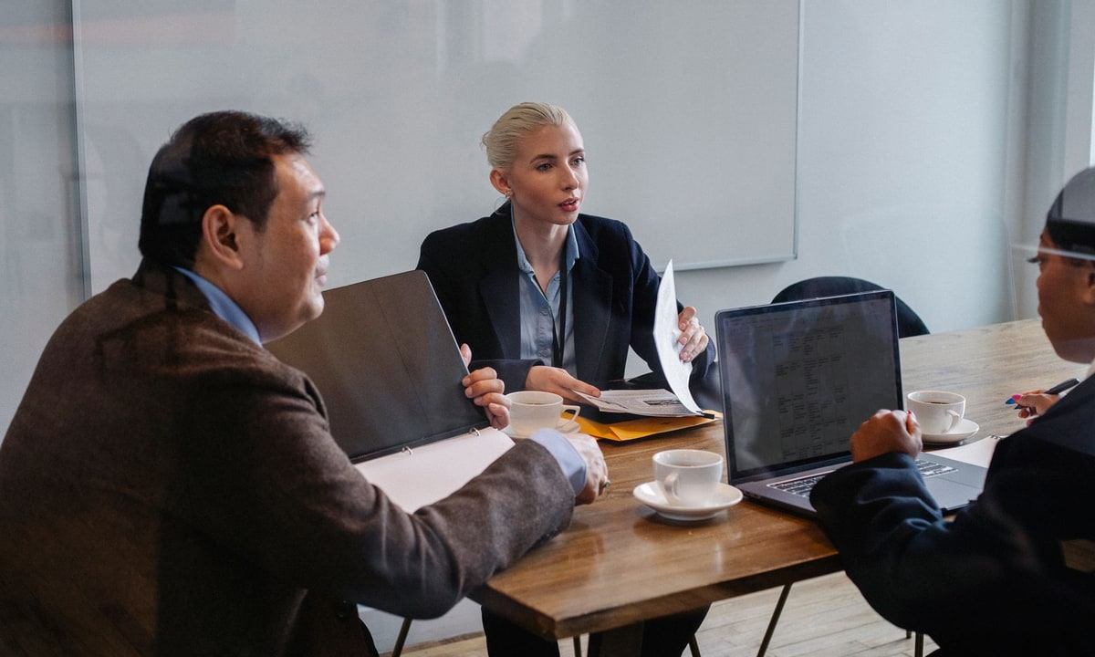 Small business team comparing CRM options around a shared table