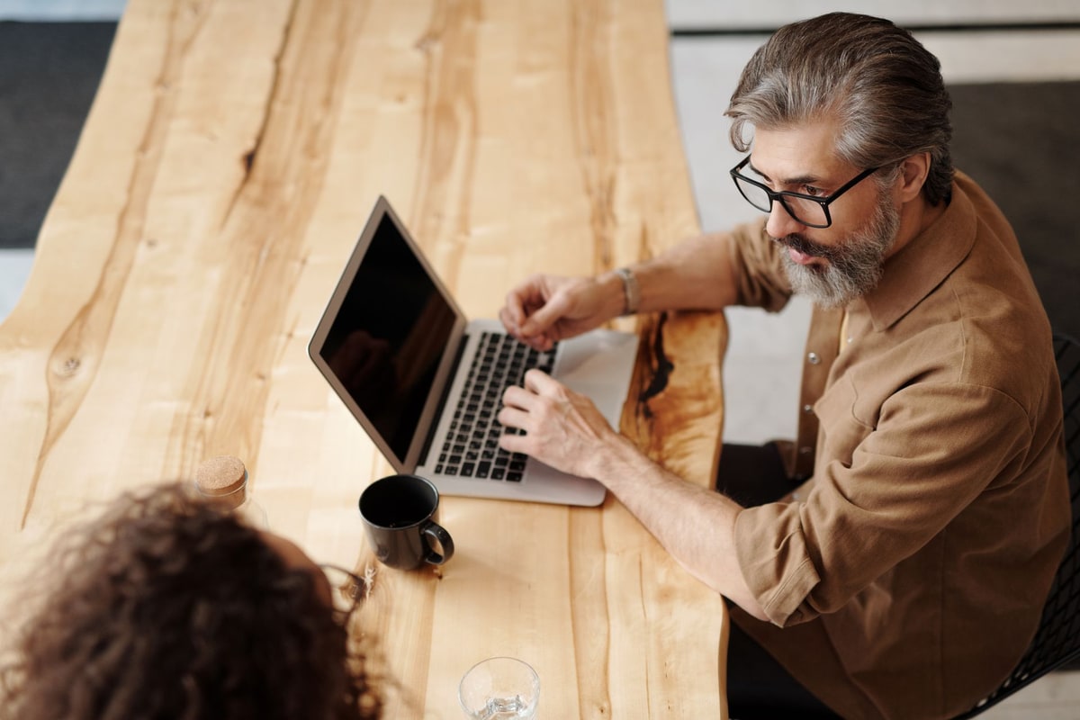 Owner comparing two software options on a laptop