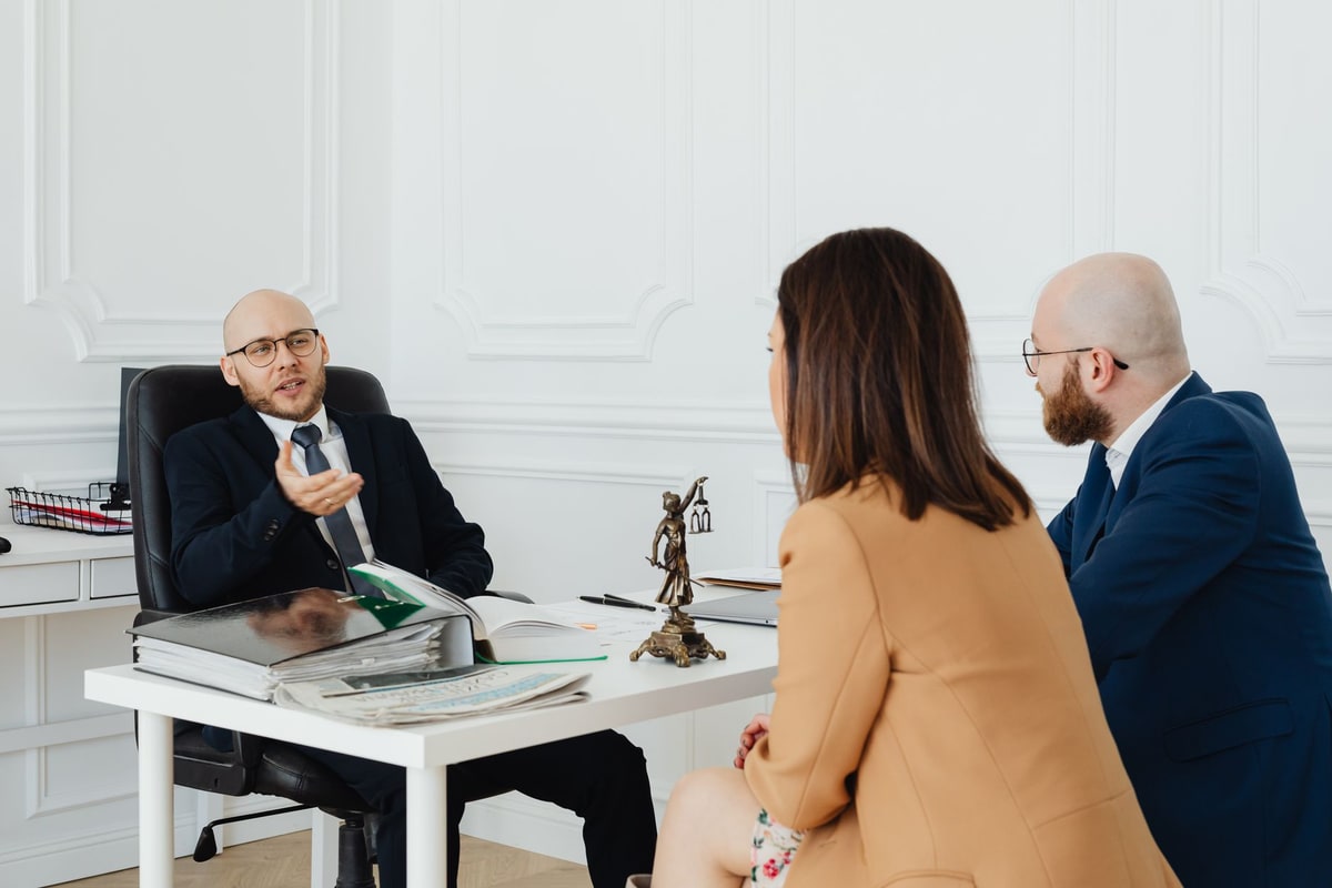 Agency account team confirming a client follow-up during an office meeting