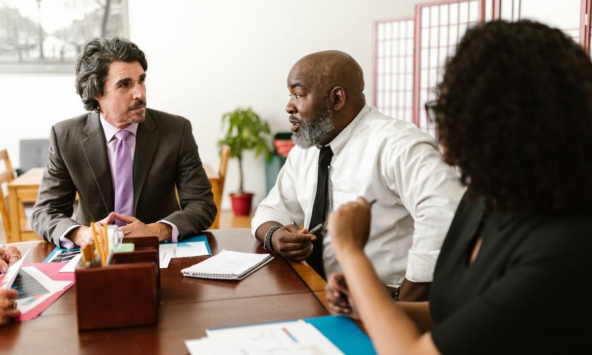 Agency team reviewing client feedback and assigning follow-up ownership