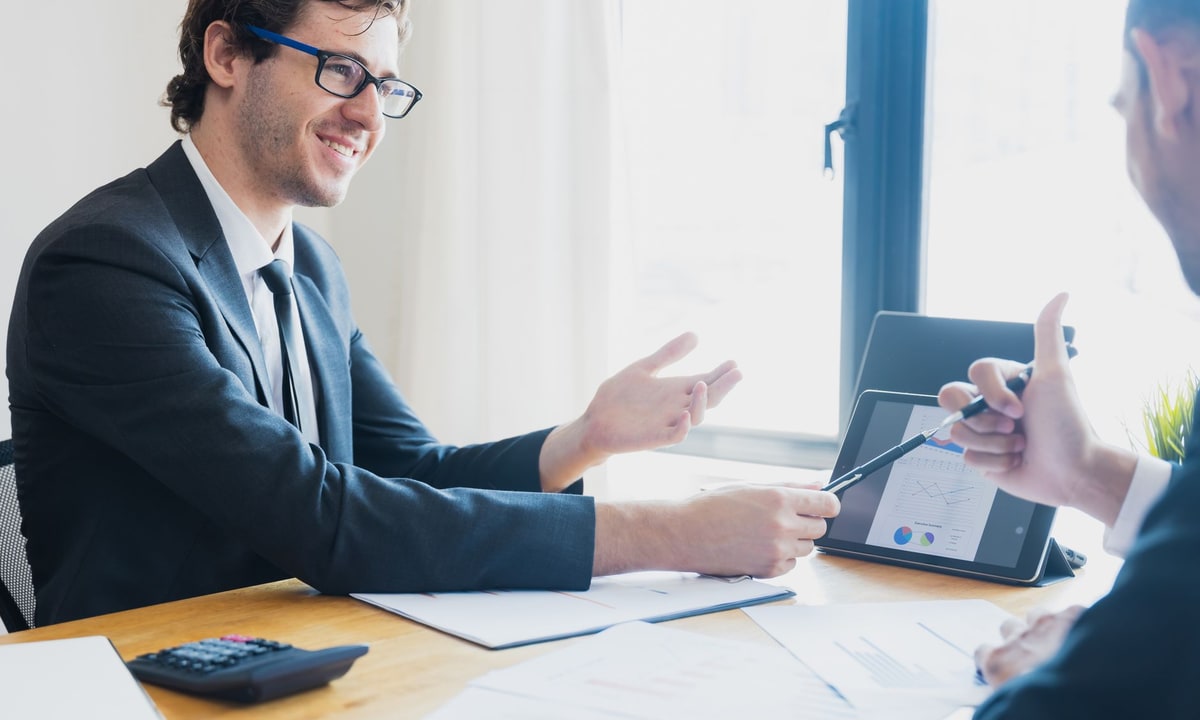 Business owner reviewing CRM automation requirements with a specialist