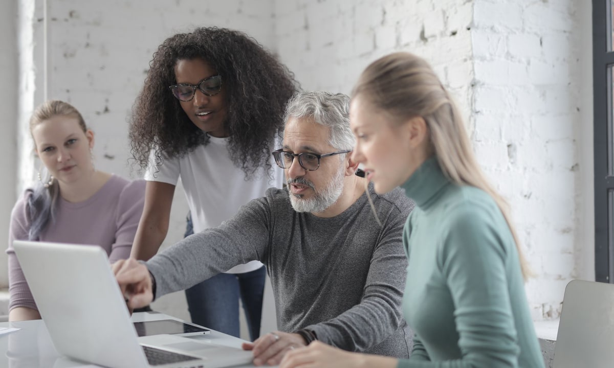 Small business team reviewing reporting dashboards on a laptop