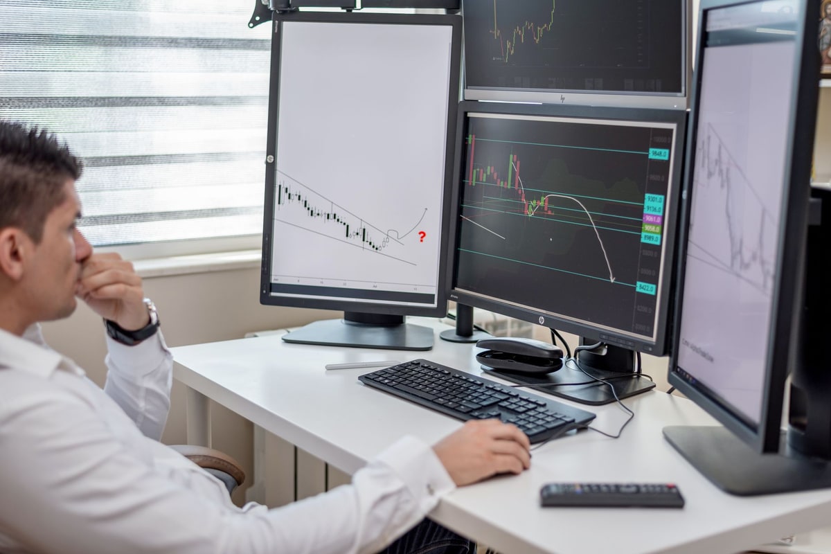 Small business owner juggling multiple screens with separate business apps