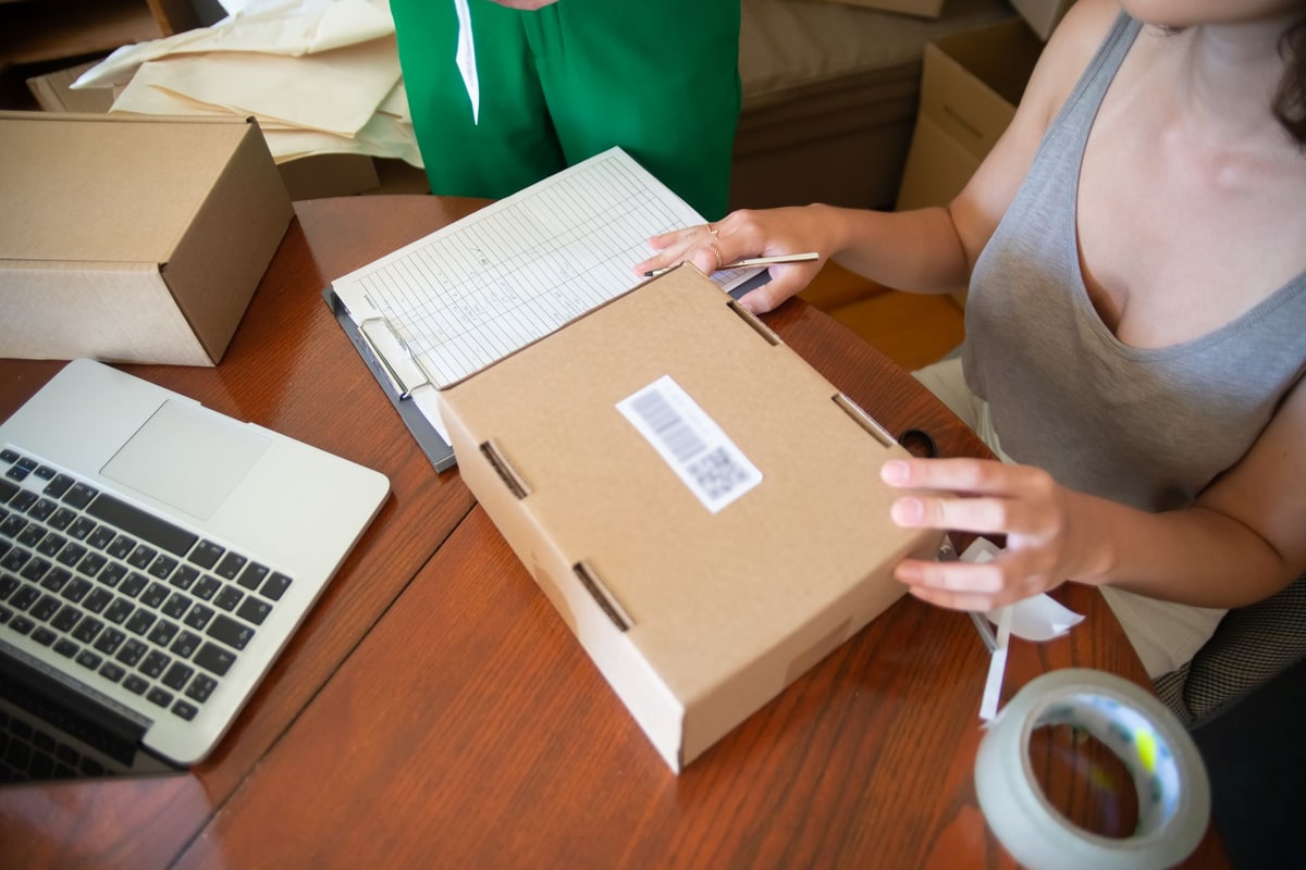 Small business owner preparing online orders at a desk