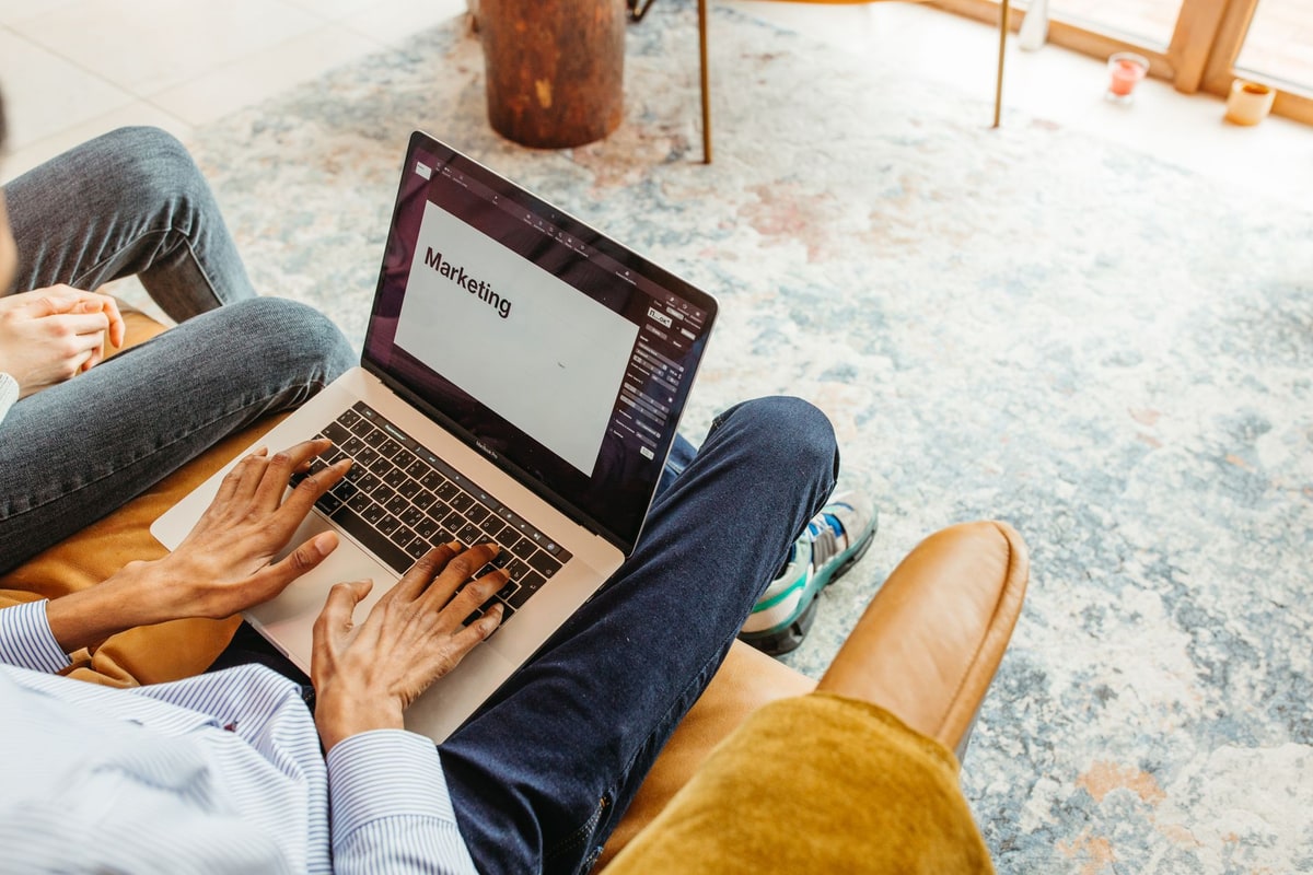 Marketing team reviewing customer records on a laptop