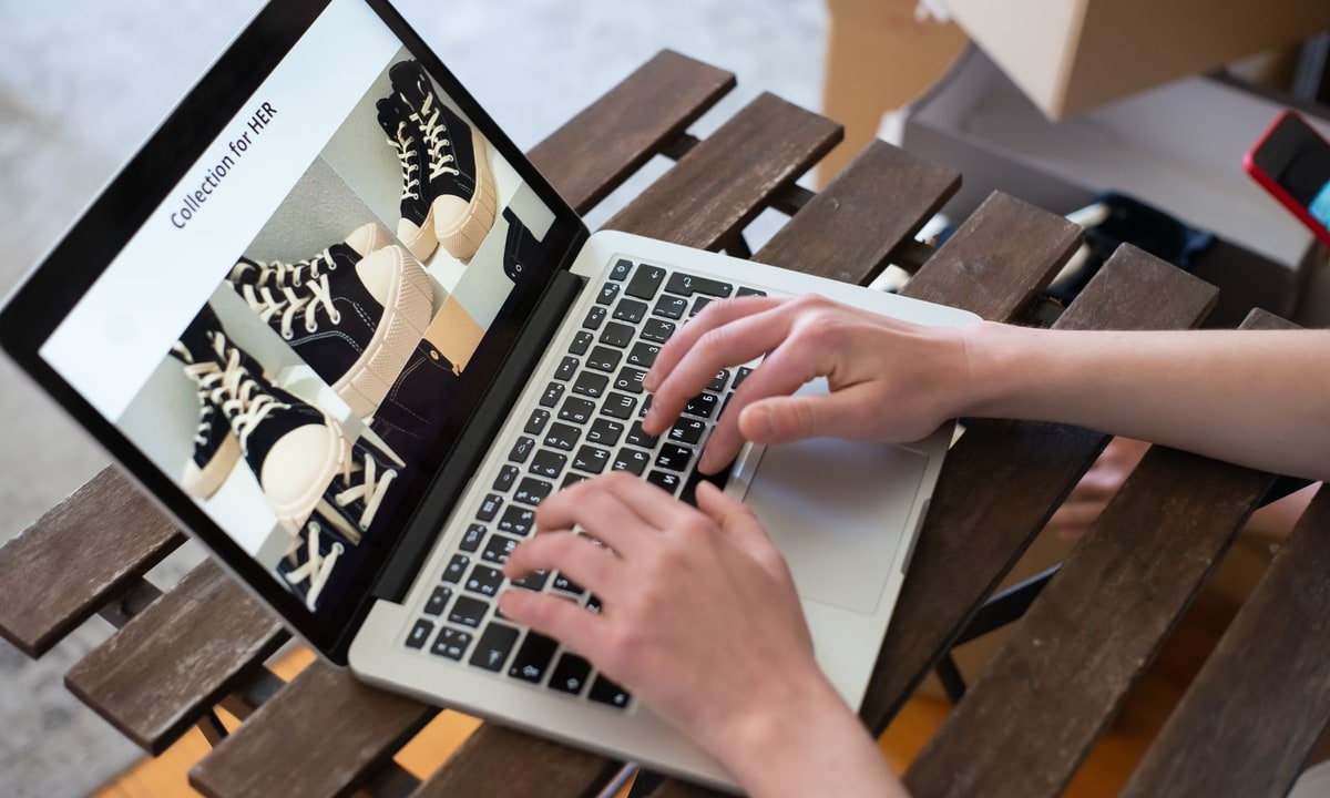 Small e-commerce team reviewing store email activity on a laptop