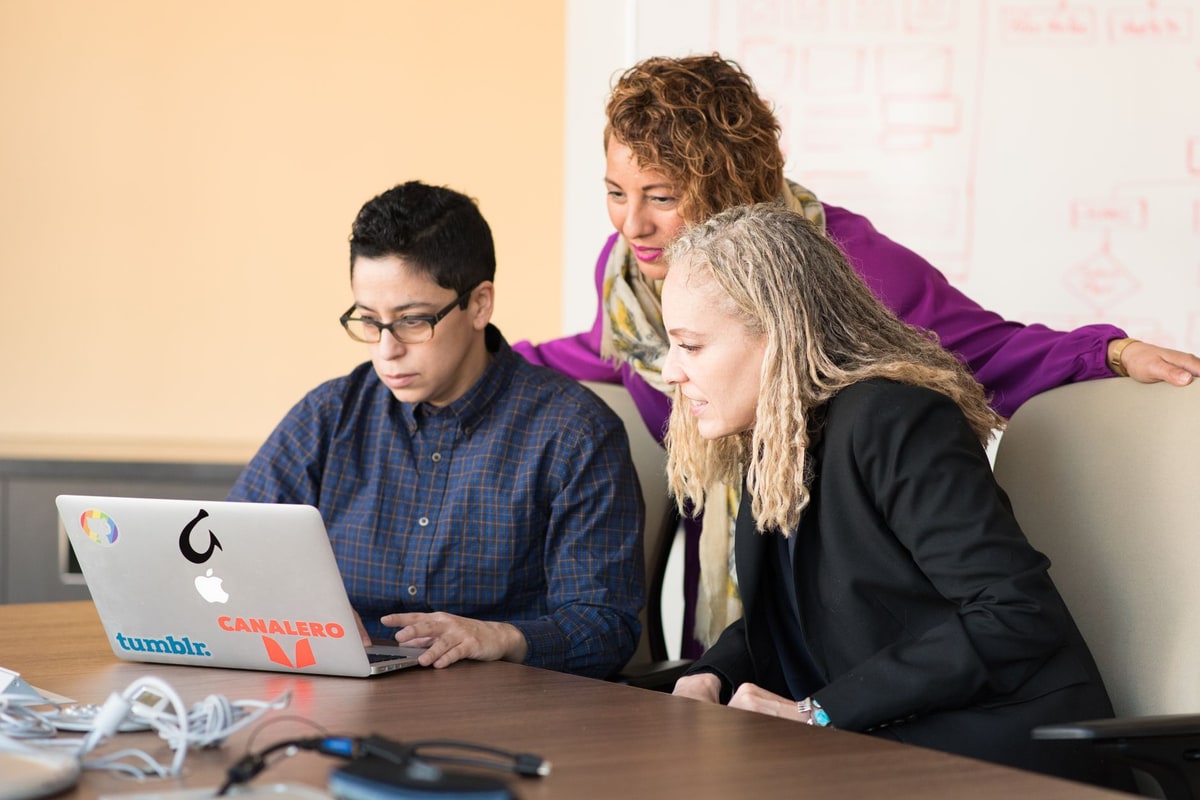 Team member sending a short follow-up message from a laptop
