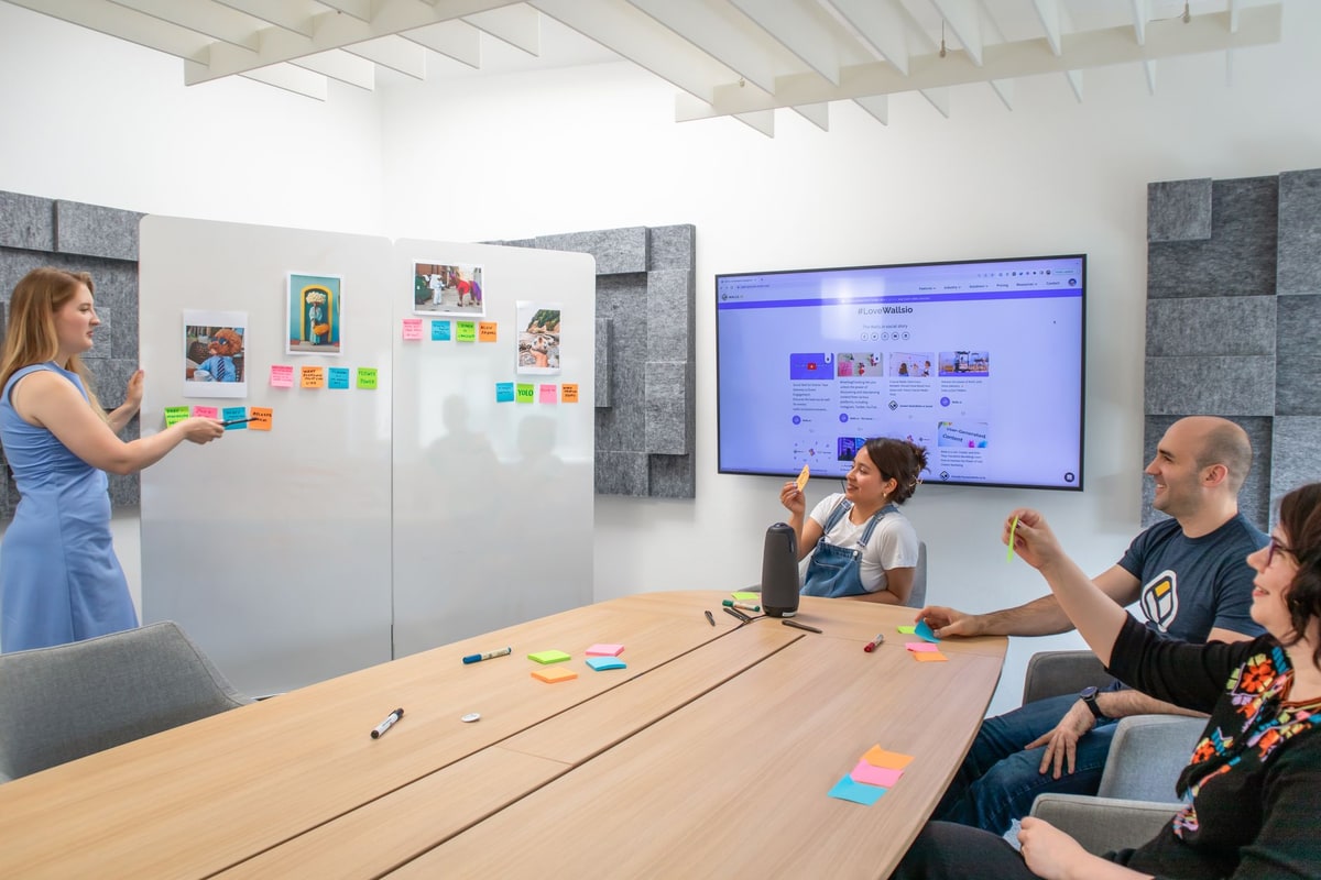 Operations and HR team mapping an employee onboarding workflow on a whiteboard