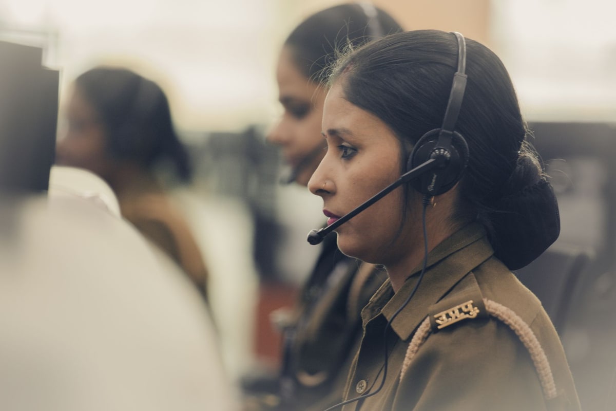 Dispatcher coordinating technicians by phone in a busy service office