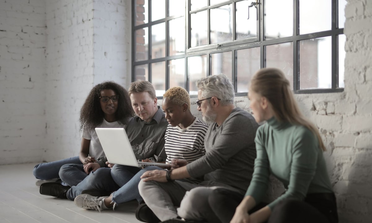 CRM team reviewing customer records on a laptop