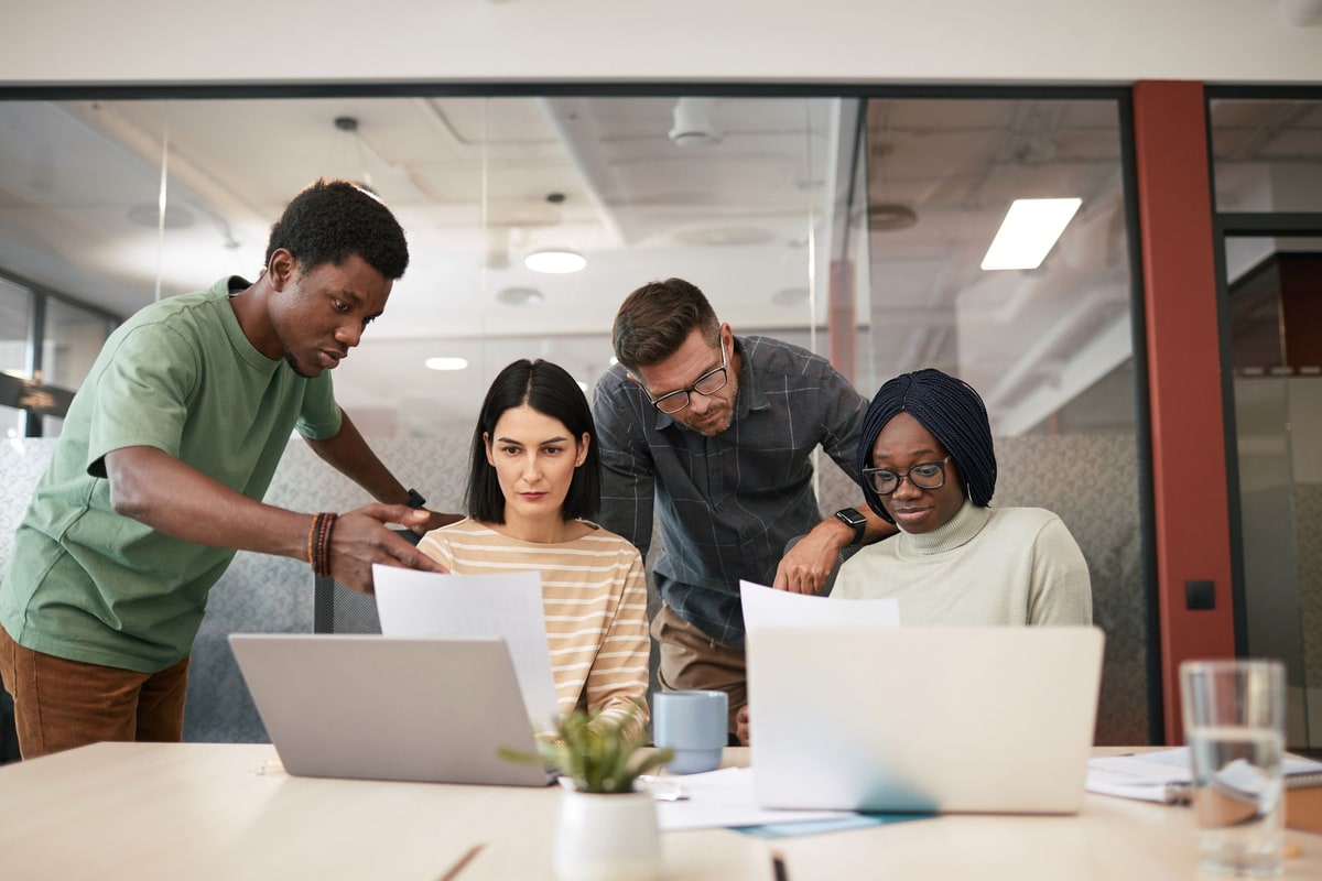 Team reviewing record fields together on a laptop