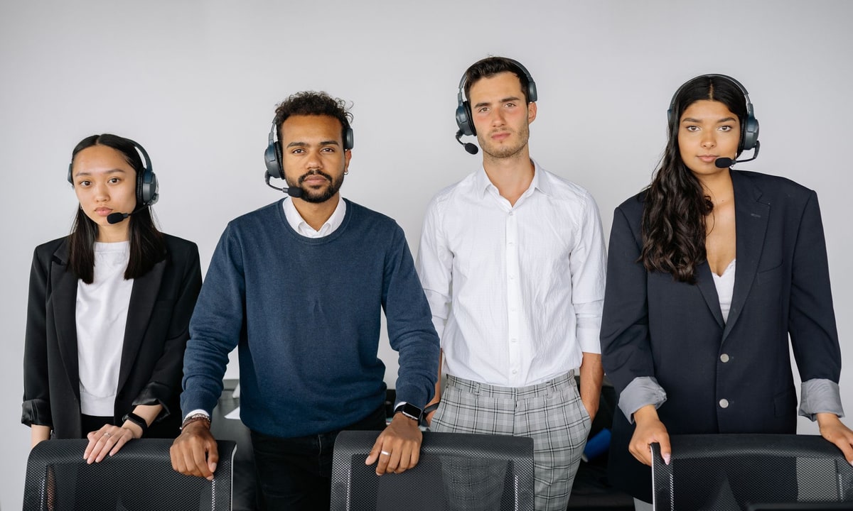 Sales team reviewing customer records together on a laptop