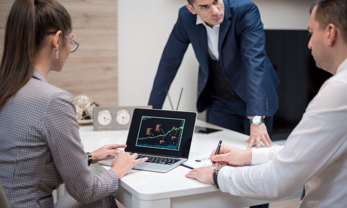 Marketing manager reviewing automation work with a small team