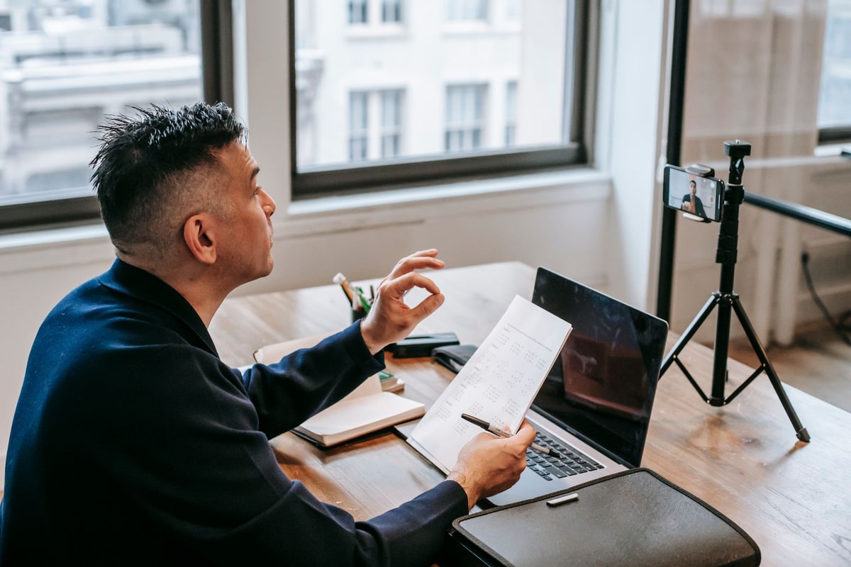 Business owner on a video call discussing a project from a home office