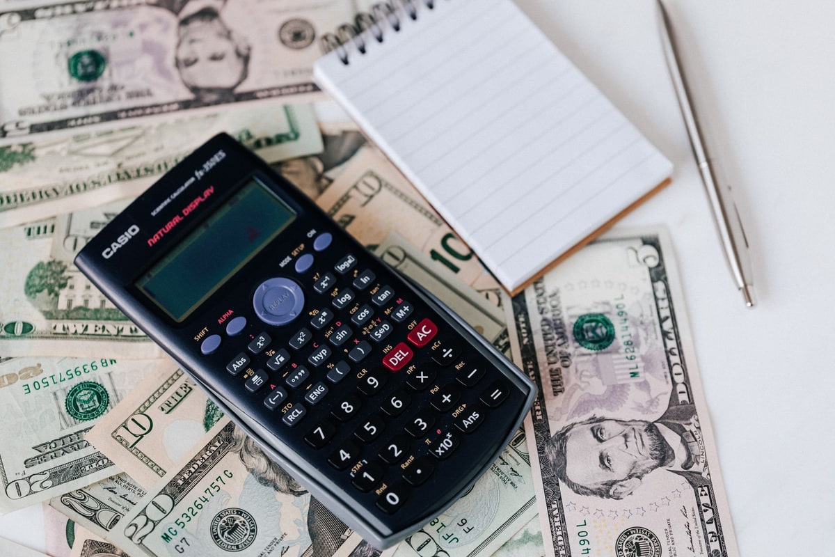 Calculator on a desk next to business paperwork and invoices