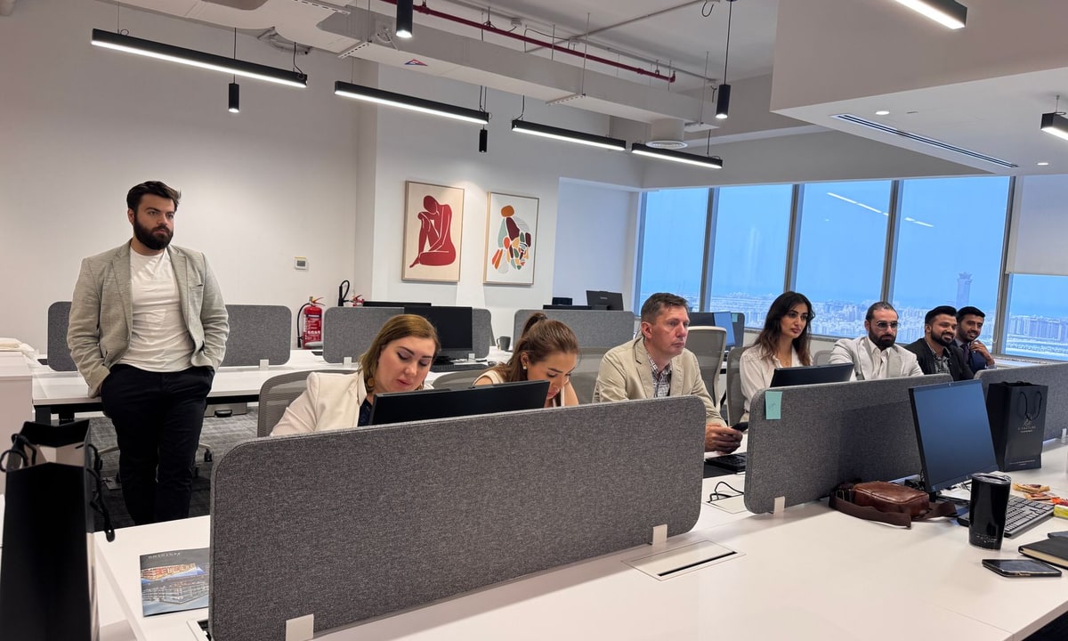 Team member following up with new leads at a computer