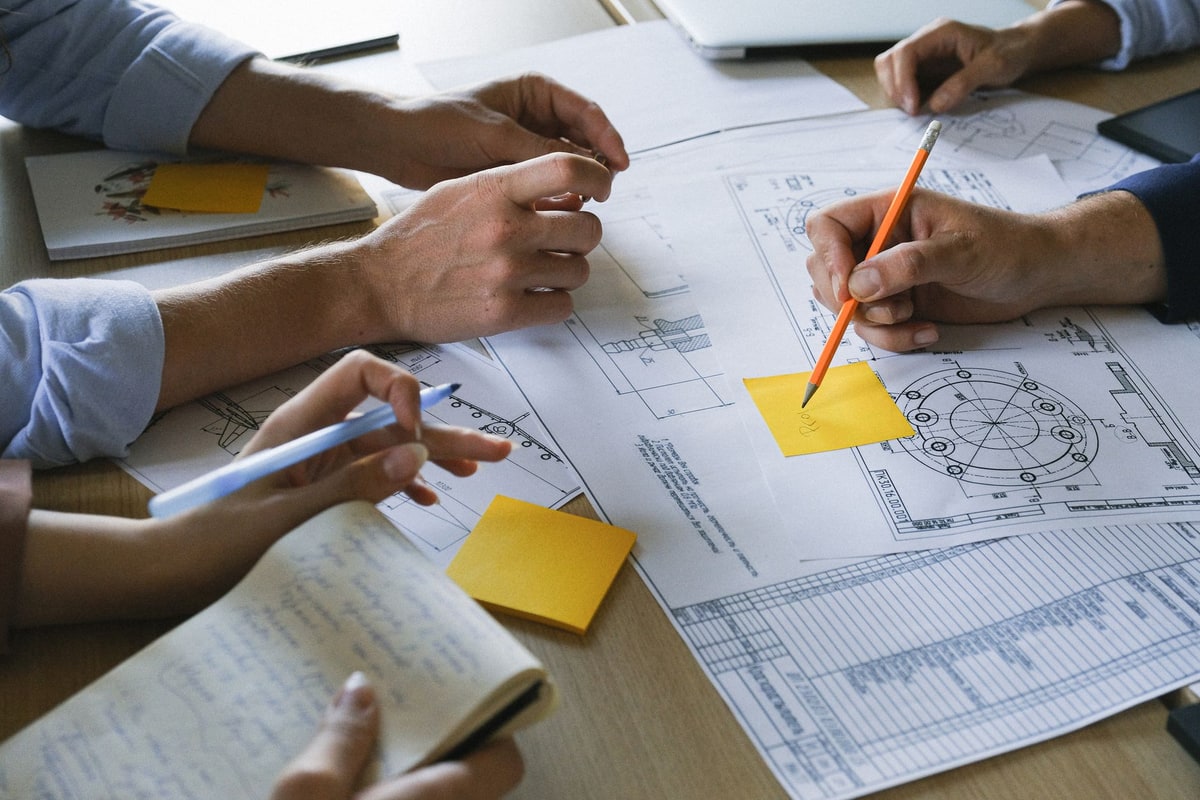 Operations team comparing an internal project plan with an external service proposal