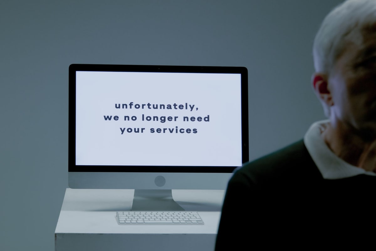 Frustrated employee looking at a cluttered CRM dashboard on a monitor