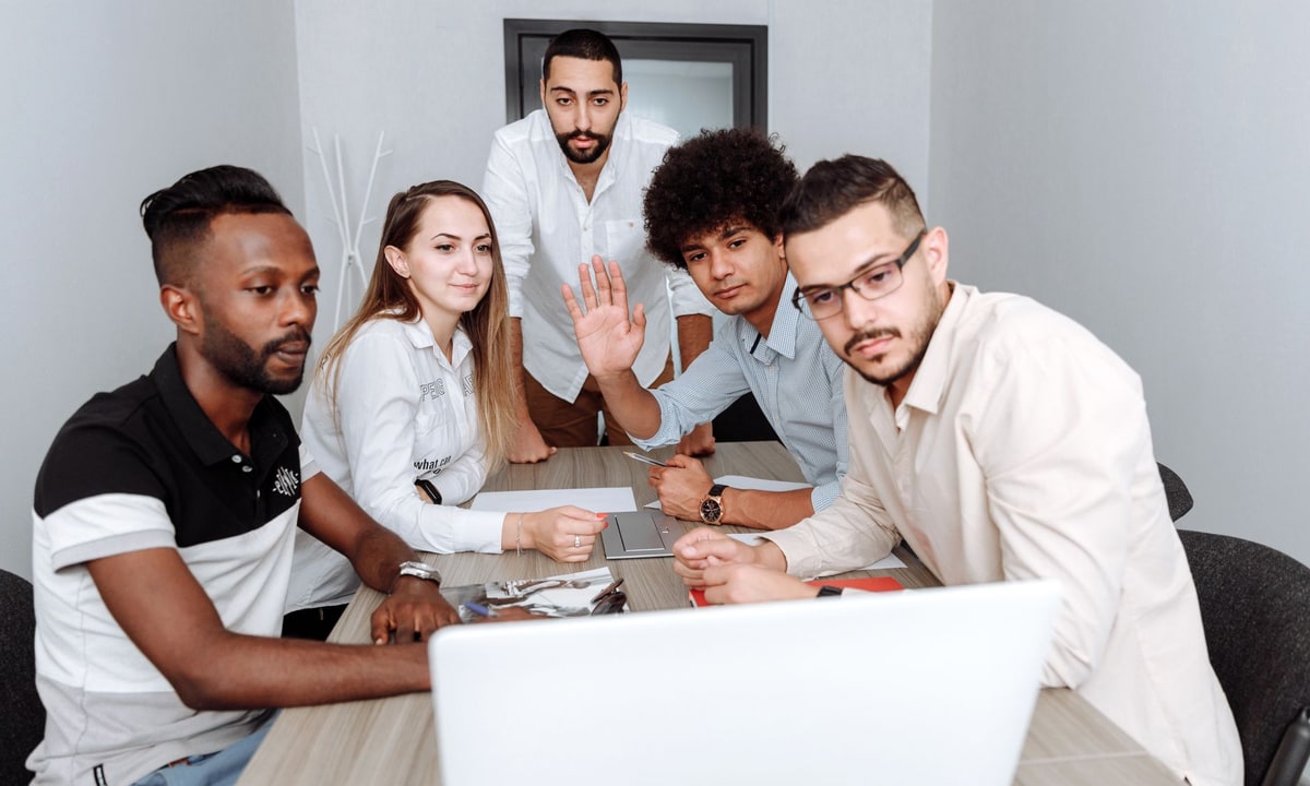 Small business team learning a CRM on a laptop during onboarding