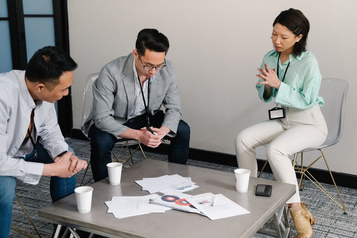 Sales team discussing follow-up tasks around a table