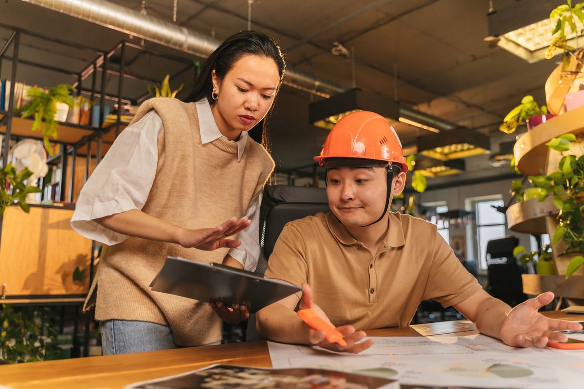 Contractor preparing an estimate on a clipboard at a worksite