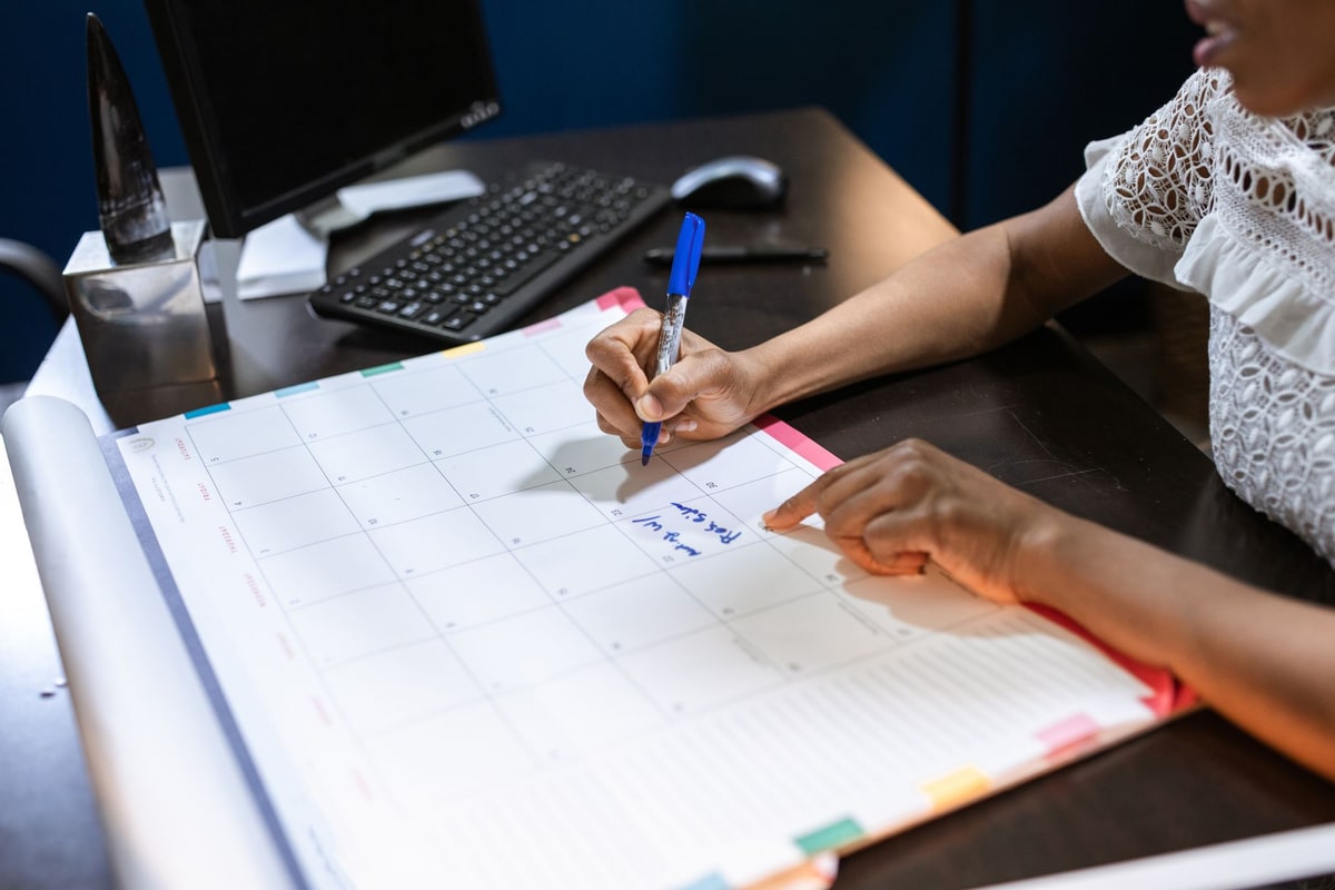 Team planning the schedule on a calendar in an office