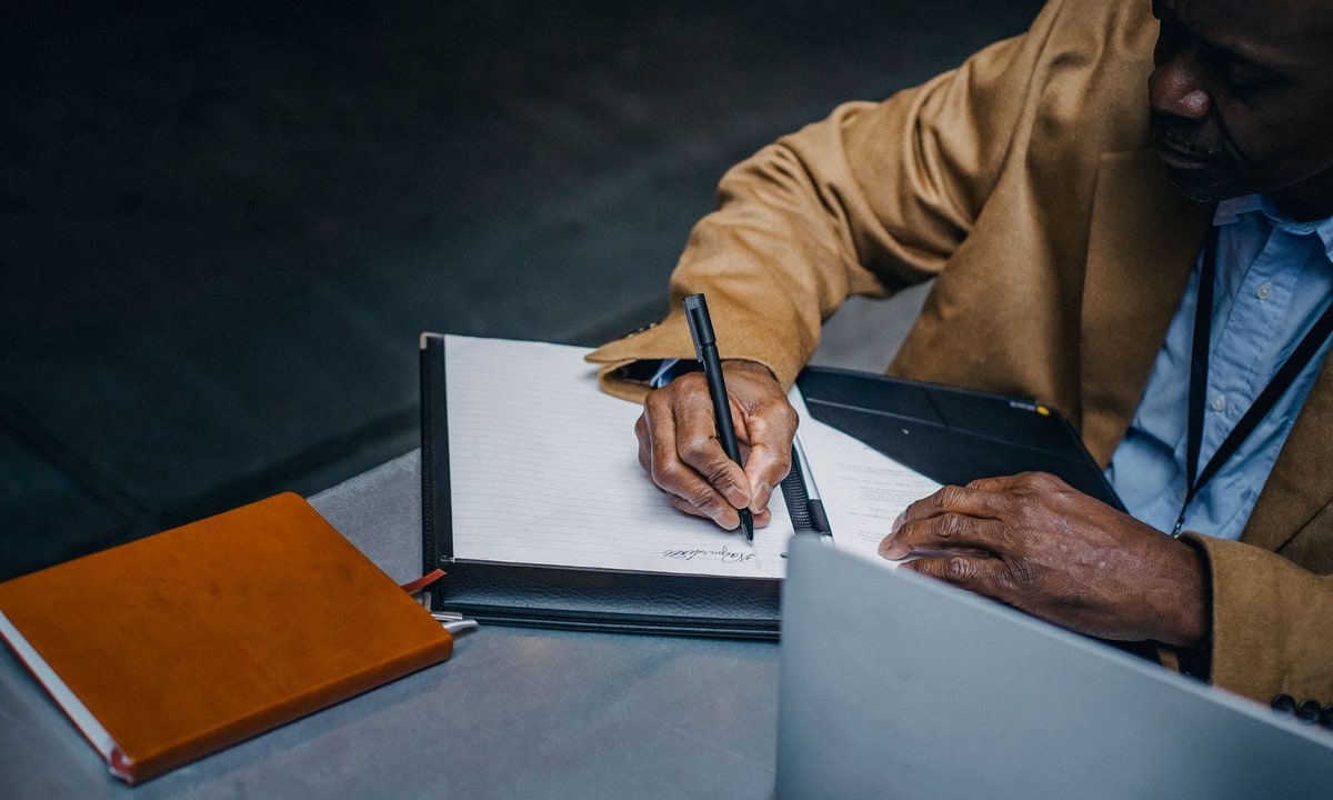Contractor writing an estimate while talking with a customer at home