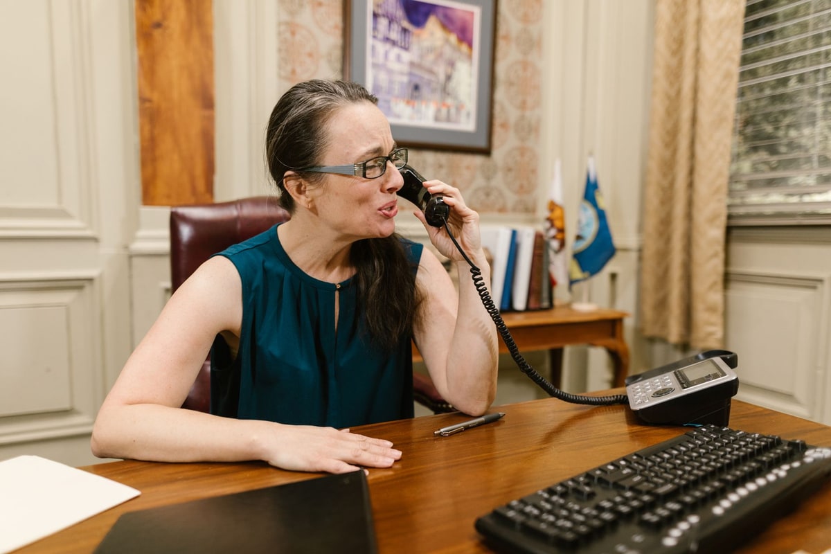 Owner finishing a phone call and checking an empty calendar