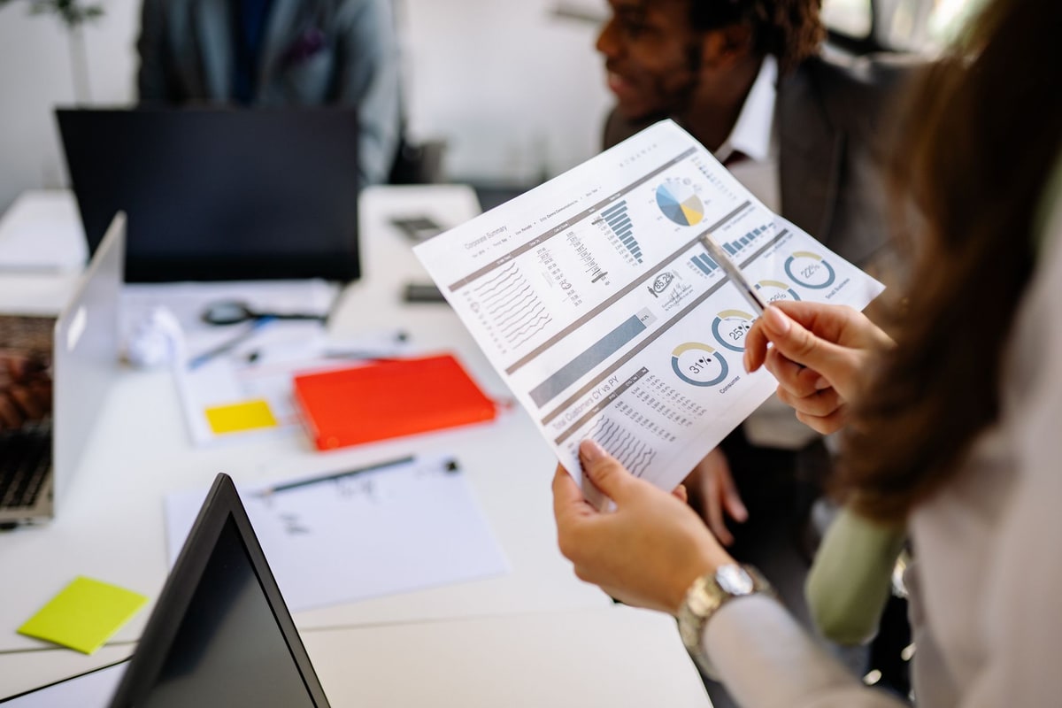 Project manager mapping steps on a whiteboard with a colleague