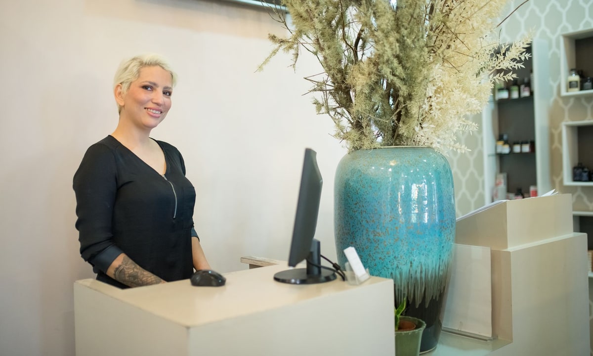 Chiropractic clinic front desk handling appointment scheduling