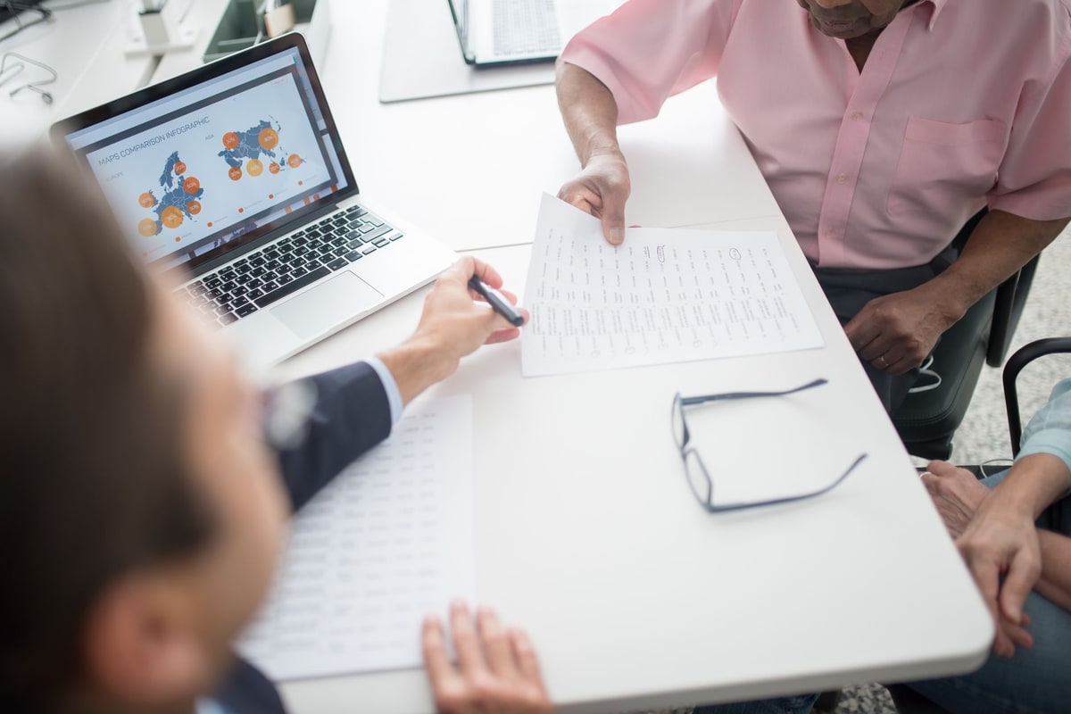 Consultant and client reviewing laptop workflow details
