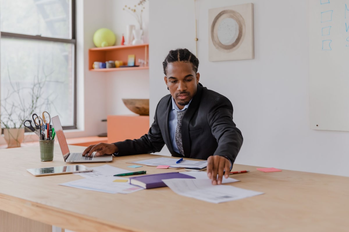 Owner comparing two service proposals side by side at a desk