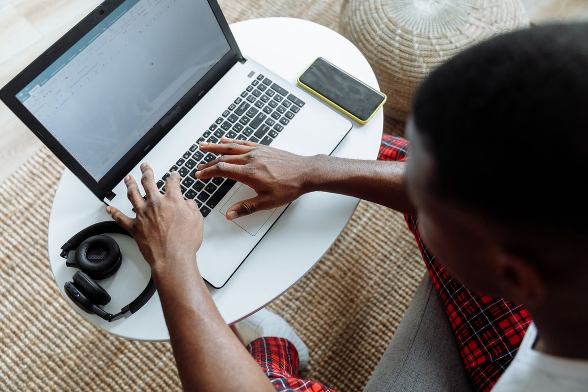 Marketing coordinator preparing social media content on a laptop